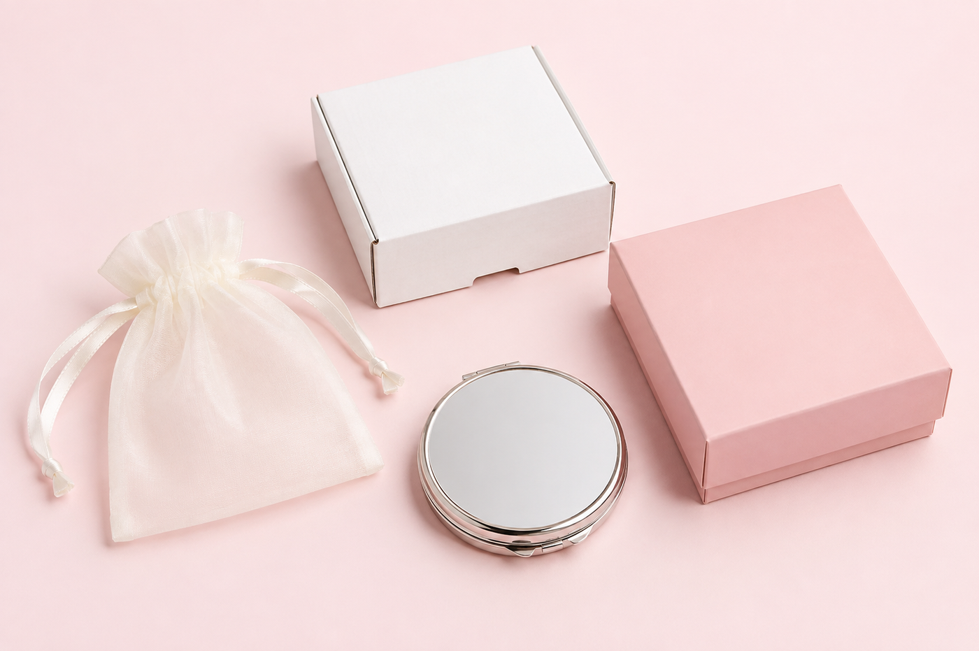 Packaging options for custom compact mirrors including a white box, pink retail box and organza bag