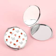 The silver plated round double-sided makeup mirror has a colored glue drop pattern