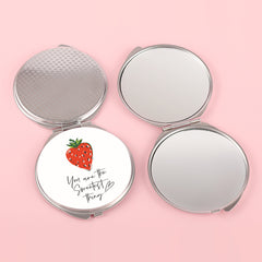 The silver plated round double-sided makeup mirror has a colored glue drop pattern