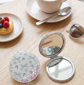 70mm Round Quicksand Dual-Sided Travel Makeup Mirror - Portable Pocket Mirror with Sparkly Flowing Glitter for Purses & Handbags - Compact Mirror with 95% High-Reflectivity Eco-Friendly Glass for Girls, Women, & Gift-Giving - Whimsical Bowknot & Hear