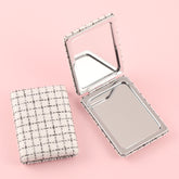 Chic 85*62mm Fabric Square Grid Makeup Mirror with Plating Silver Metal Frame, Available in White, Purple, and Khaki. Perfect for a refined look anytime, anywhere