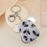Dog-head mirror keychain with black butterfly print and white PU cover