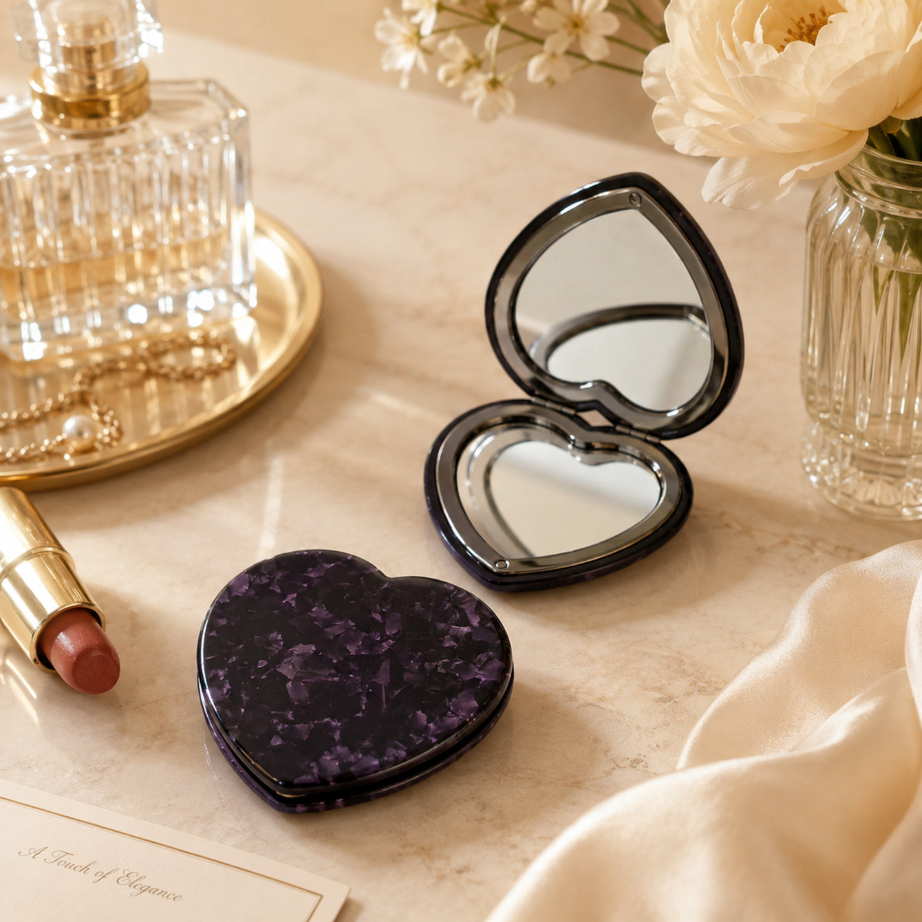 Open and closed heart-shaped acetate compact mirrors in a light luxury beauty scene