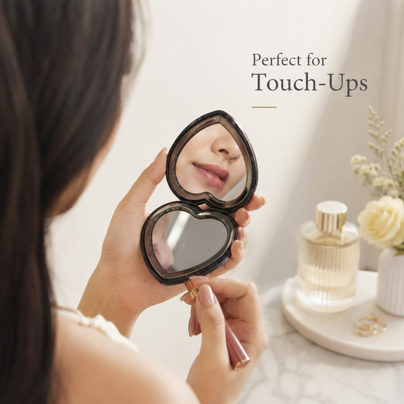 Heart-shaped 1X and 3X compact mirror used for makeup touch-ups