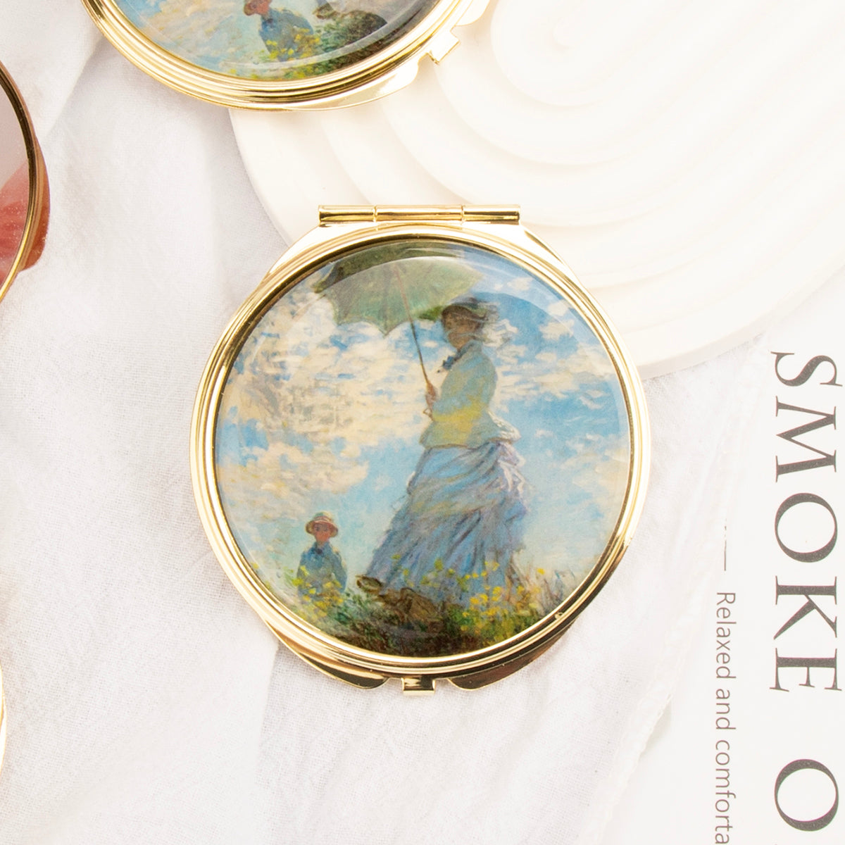 Gold folding compact mirror with woman holding parasol painting