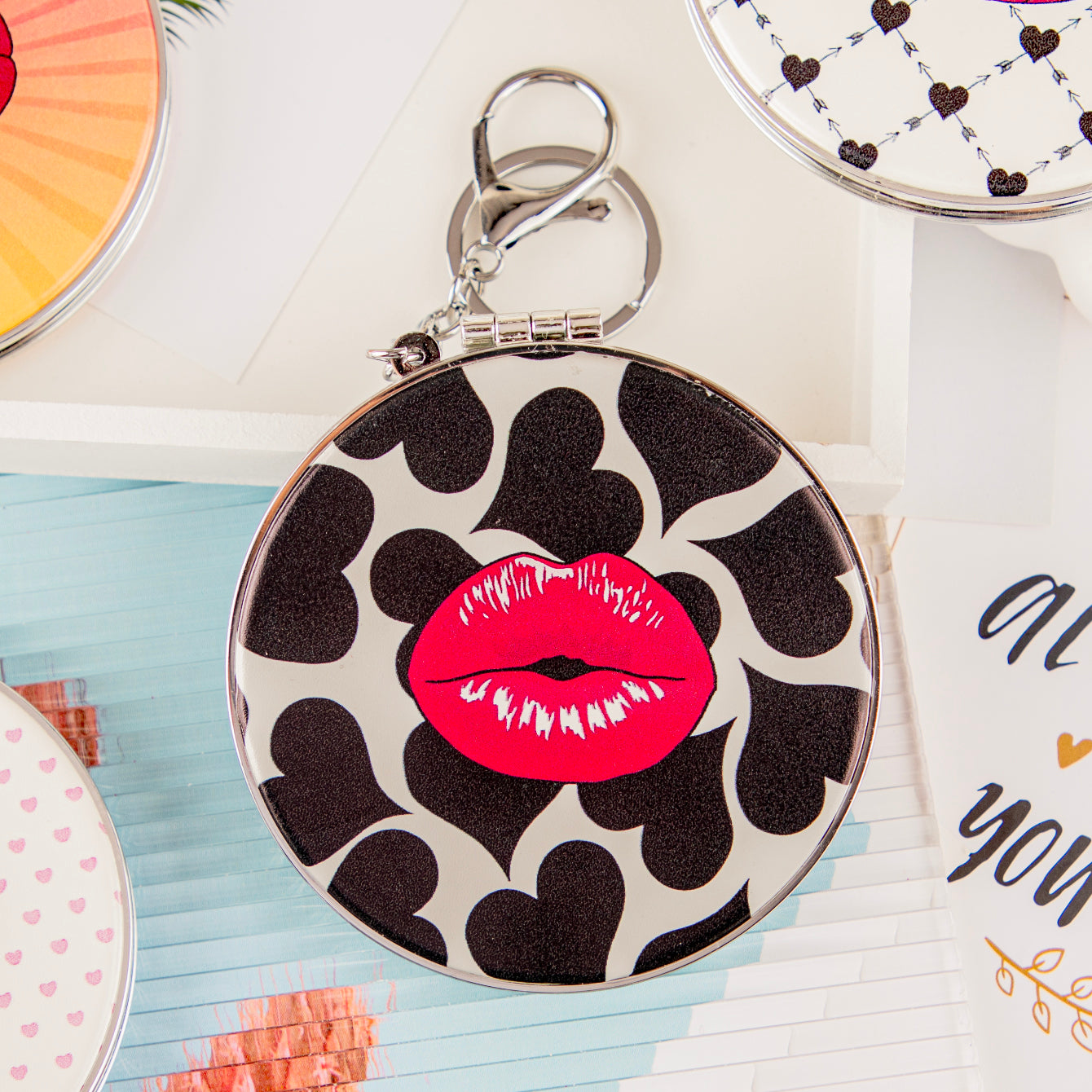 Red lips PU mirror keychain with black hearts on white background