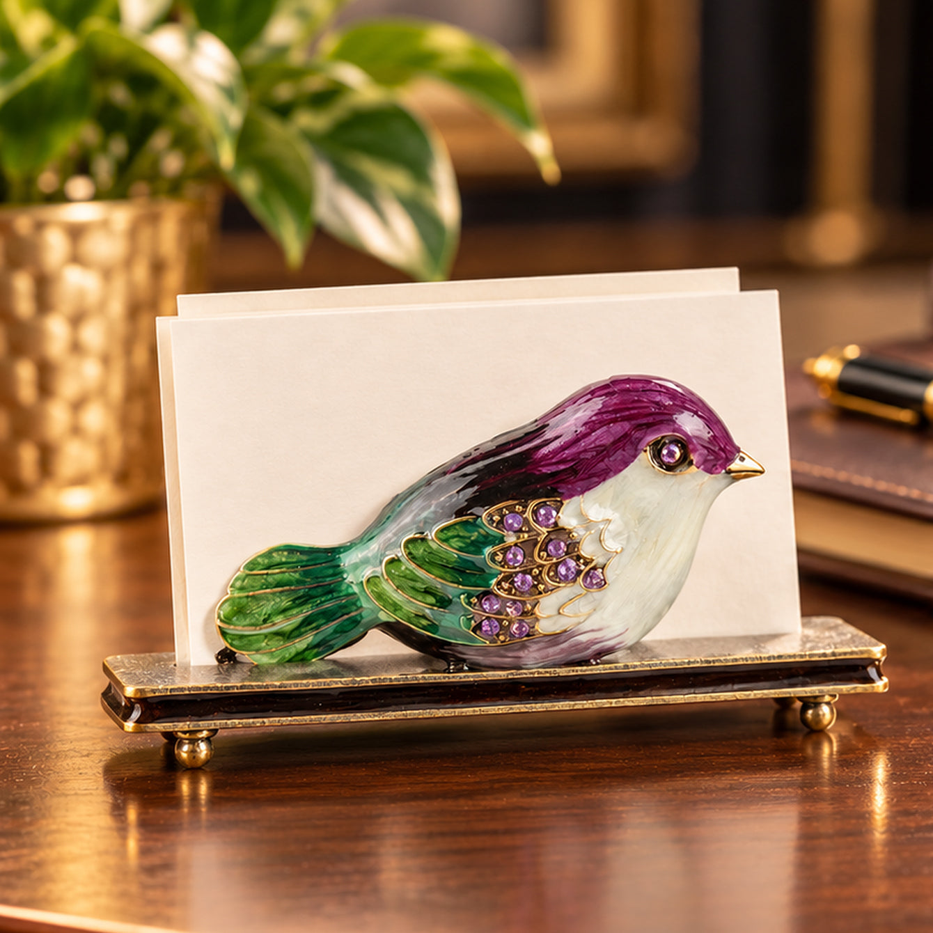 HQ390004 purple and green bird alloy business card holder displaying business cards on an elegant office desk